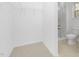 Spacious walk-in closet with carpet and wire shelving, conveniently attached to a bathroom with a glass enclosed shower at 100 Sequoia Dr # 2387, Louisburg, NC 27549
