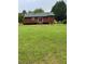 Backyard features grass and a quaint exterior of a home at 1018 Lakeview Dr, Cedar Grove, NC 27231