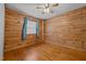 Cozy bedroom featuring wood walls and flooring at 1018 Lakeview Dr, Cedar Grove, NC 27231