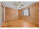 Cozy bedroom with wood walls and hardwood floors at 1018 Lakeview Dr, Cedar Grove, NC 27231