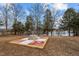 Landscaped fire pit area with stone fire pit and pavers at 1018 Lakeview Dr, Cedar Grove, NC 27231