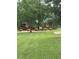 Quaint single-story home nestled among mature trees on a lush green lawn at 1018 Lakeview Dr, Cedar Grove, NC 27231