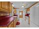 Kitchen with oak cabinets, red tile countertops, and modern appliances at 1018 Lakeview Dr, Cedar Grove, NC 27231