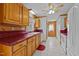 Kitchen boasts oak cabinets, red tile countertops, and a view into the dining area at 1018 Lakeview Dr, Cedar Grove, NC 27231