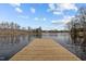 Wooden dock extending over calm lake water at 1018 Lakeview Dr, Cedar Grove, NC 27231