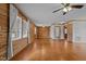 Hardwood floor living room, wood walls, and ceiling fan at 1018 Lakeview Dr, Cedar Grove, NC 27231