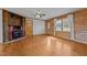 Living room with hardwood floors, wood walls, and a cozy fireplace at 1018 Lakeview Dr, Cedar Grove, NC 27231