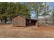 Rustic wooden storage shed with covered workspace, located lakeside at 1018 Lakeview Dr, Cedar Grove, NC 27231