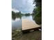 This property includes a private wooden dock on a calm lake at 1018 Lakeview Dr, Cedar Grove, NC 27231