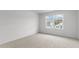 Bright bedroom featuring neutral wall-to-wall carpeting and large window at 1025 Middlecrest Dr, Rocky Mount, NC 27804