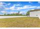 This large backyard is surrounded by a white vinyl fence at 108 Bonnie Girl Ct, Lillington, NC 27546
