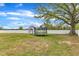 The backyard features an outbuilding, large shade tree, and trampoline with a white vinyl fence at 108 Bonnie Girl Ct, Lillington, NC 27546
