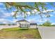 Large backyard with a trampoline, outbuilding, fenced perimeter and a two-story house at 108 Bonnie Girl Ct, Lillington, NC 27546