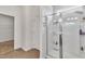 Tiled bathroom with glass shower, white walls, and walk in closet at 108 Bonnie Girl Ct, Lillington, NC 27546