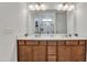 Bathroom features double vanity with white counters and stained wood cabinets at 108 Bonnie Girl Ct, Lillington, NC 27546
