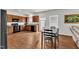 Open dining area features dark wood cabinets, black appliances, and a wooden table with chairs at 108 Bonnie Girl Ct, Lillington, NC 27546