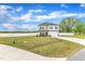 Exterior view of a two-story home featuring a front yard, driveway and white fence in the background at 108 Bonnie Girl Ct, Lillington, NC 27546