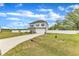Exterior view of a two-story home with a driveway, front yard, basketball hoop and white fence at 108 Bonnie Girl Ct, Lillington, NC 27546