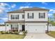 Two-story home featuring a front-facing two-car garage, white siding, and dark shutters at 108 Bonnie Girl Ct, Lillington, NC 27546