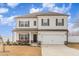 Two-story house with white siding, dark gray trim, and a two-car garage at 108 Bonnie Girl Ct, Lillington, NC 27546