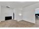 Open area with carpet flooring, bright white walls, and an entrance to another room at 108 Bonnie Girl Ct, Lillington, NC 27546
