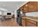 Open concept kitchen with stainless steel refrigerator leading to dining and living areas at 108 Bonnie Girl Ct, Lillington, NC 27546