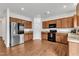 Well-equipped kitchen features stainless steel appliances, including a modern refrigerator and dark wood cabinets at 108 Bonnie Girl Ct, Lillington, NC 27546