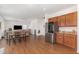 Kitchen with wood cabinets, granite counters, and stainless steel appliances at 108 Bonnie Girl Ct, Lillington, NC 27546