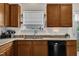 Charming kitchen featuring granite countertops, stainless steel sink, and wood cabinets at 108 Bonnie Girl Ct, Lillington, NC 27546