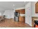Bright, open kitchen leading to living area with stainless steel fridge, perfect for seamless entertaining at 108 Bonnie Girl Ct, Lillington, NC 27546