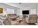 Cozy living room features a large flat-screen TV and plush, neutral-toned reclining furniture at 108 Bonnie Girl Ct, Lillington, NC 27546