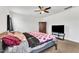 Main bedroom with ceiling fan, carpet, armoire, and queen bed with decorative bedding at 108 Bonnie Girl Ct, Lillington, NC 27546