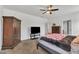 Main bedroom features queen bed, ceiling fan, armoire, and carpet at 108 Bonnie Girl Ct, Lillington, NC 27546