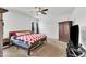 Main bedroom features a ceiling fan, carpet, queen bed, and armoire at 108 Bonnie Girl Ct, Lillington, NC 27546