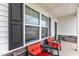 Close up of the front porch with chairs, table, stone accents and a view of a window at 108 Bonnie Girl Ct, Lillington, NC 27546