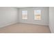 Spacious bedroom with two windows and carpet at 1104 Middlecrest Dr, Rocky Mount, NC 27804