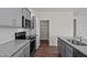 Modern kitchen with gray cabinets, granite countertops, and stainless steel appliances at 1104 Middlecrest Dr, Rocky Mount, NC 27804
