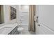 Clean bathroom with a shower/tub combo, gray vanity, and neutral decor at 1113 Middlecrest Dr, Rocky Mount, NC 27804