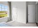 Well-lit bedroom with a large window, carpet flooring, and a spacious closet at 1113 Middlecrest Dr, Rocky Mount, NC 27804