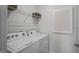Laundry room with washer, dryer, and ample overhead shelving at 1113 Middlecrest Dr, Rocky Mount, NC 27804