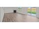 Gathering room with fireplace, wood-look floors, and sliding glass doors at 1121 Middlecrest Dr, Rocky Mount, NC 27804