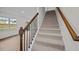 Carpeted staircase with wood railing leading to the second floor at 1121 Middlecrest Dr, Rocky Mount, NC 27804