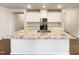 Kitchen island with granite countertop and white cabinetry at 1134 Chestnut Bluff, Apex, NC 27502