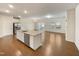 Open concept kitchen with large island and hardwood floors at 1134 Chestnut Bluff, Apex, NC 27502