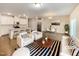 Open concept living room and kitchen with hardwood floors, and modern furniture at 1134 Chestnut Bluff, Apex, NC 27502