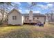 House backyard with deck, playset, and trampoline at 116 Primrose Ln, Clayton, NC 27520