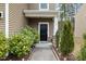 Inviting front entrance with a black door and nicely landscaped walkway at 116 Rosebud Lane Ln, Durham, NC 27704