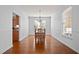 Bright dining room featuring hardwood floors, a classic chandelier, and ample natural light at 1201 Bethpage Dr, Mebane, NC 27302