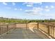 Outdoor wooden deck that looks out onto a wooded green space and open blue sky at 150 Brookhaven Dr, Spring Hope, NC 27882