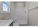 This bathroom features a shower with white walls, a window, and a view of the sky and trees at 150 Brookhaven Dr, Spring Hope, NC 27882